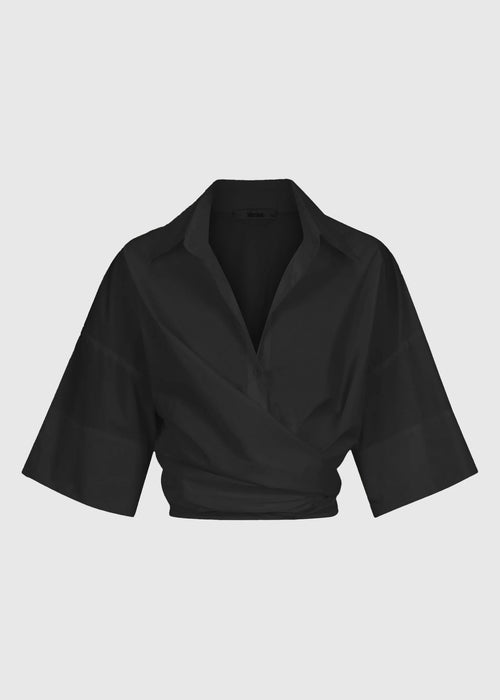 Black cropped shirt on a light grey background