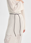 White knit dress with a brown belt on a white background