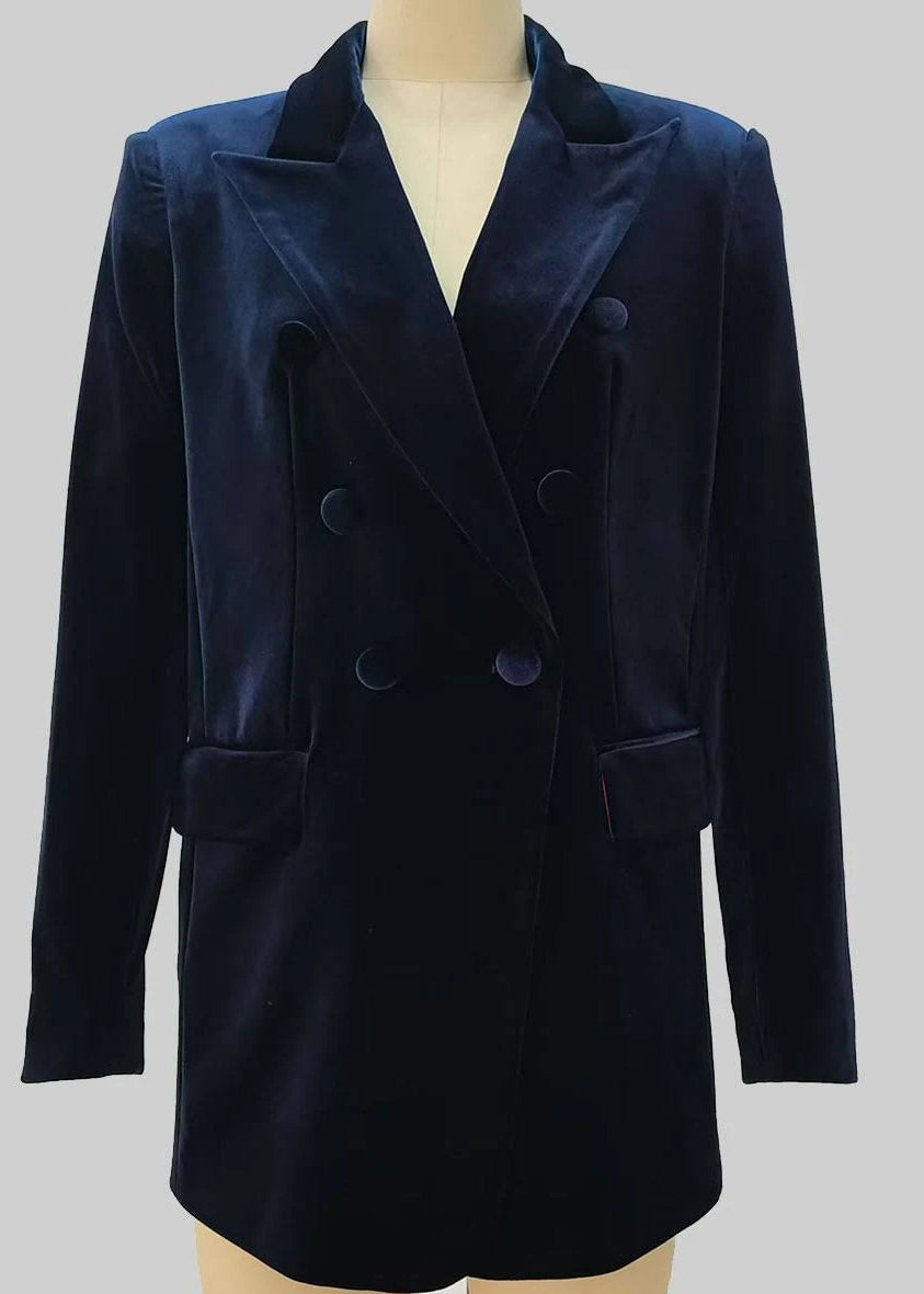 A dark navy blue velvet double-breasted blazer jacket displayed on a beige mannequin torso against a solid grey background.
