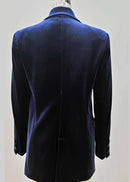A dark navy blue velvet double-breasted blazer jacket displayed on a beige mannequin torso against a solid grey background.