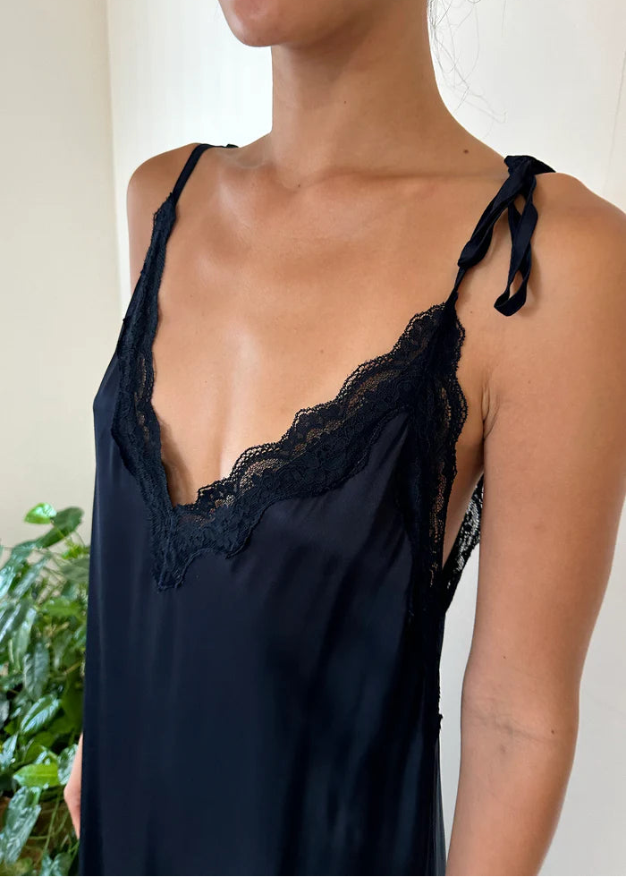 Woman wearing a navy dress  on a white background