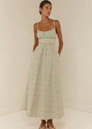 Woman wearing a floral dress against a plain background