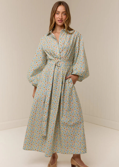 Woman wearing a floral dress with a plain background