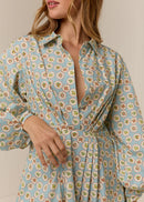 Woman wearing a floral dress with a plain background