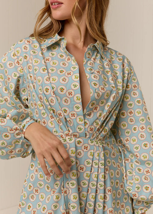 Woman wearing a floral dress with a plain background