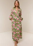 Woman wearing a floral dress with pink flowers on a white background