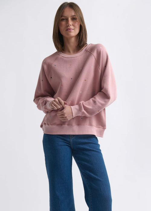 Woman wearing a pink sweatshirt on a white background