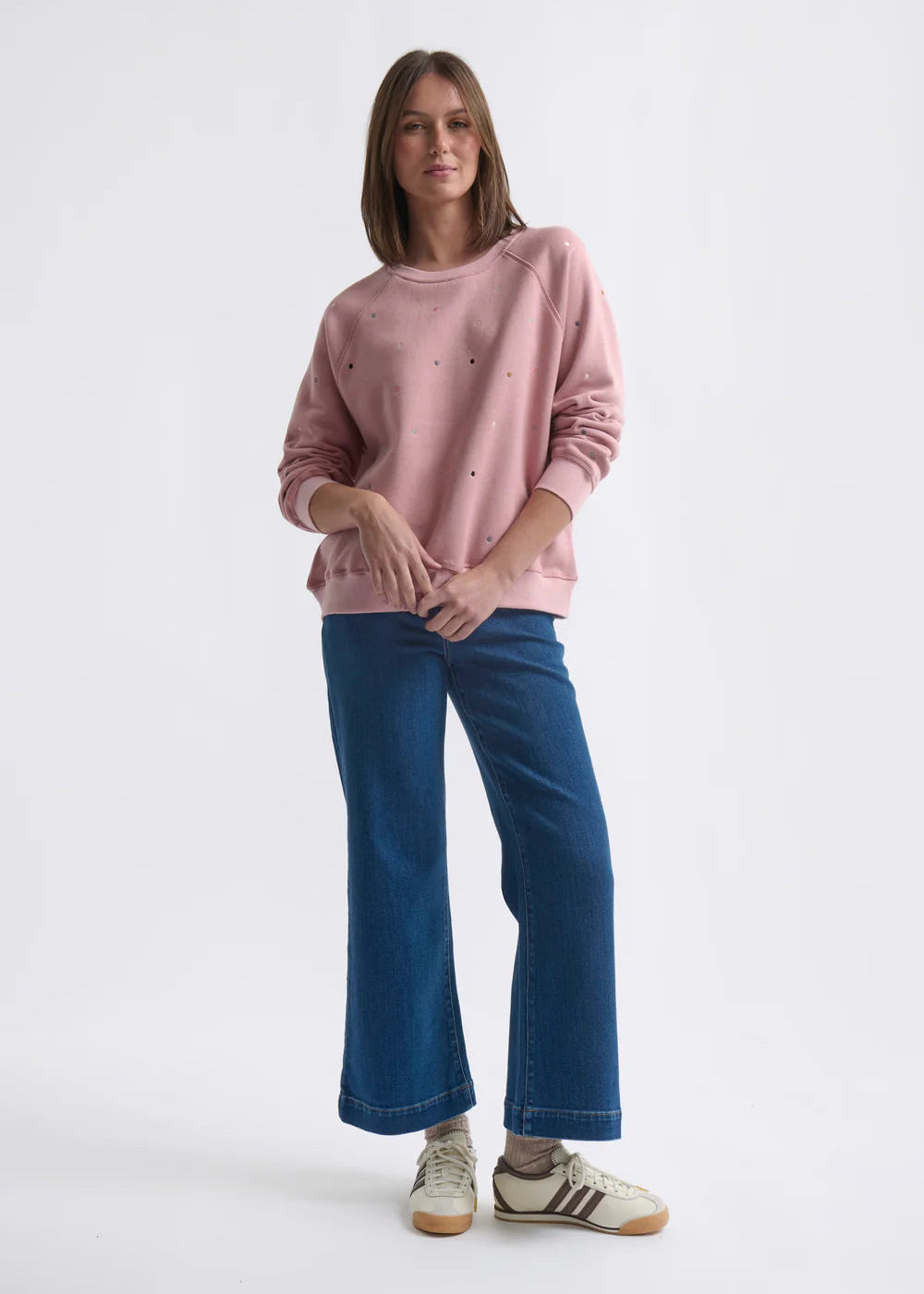 Woman wearing a pink sweatshirt on a white background
