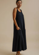 Woman wearing blue dress on beige background