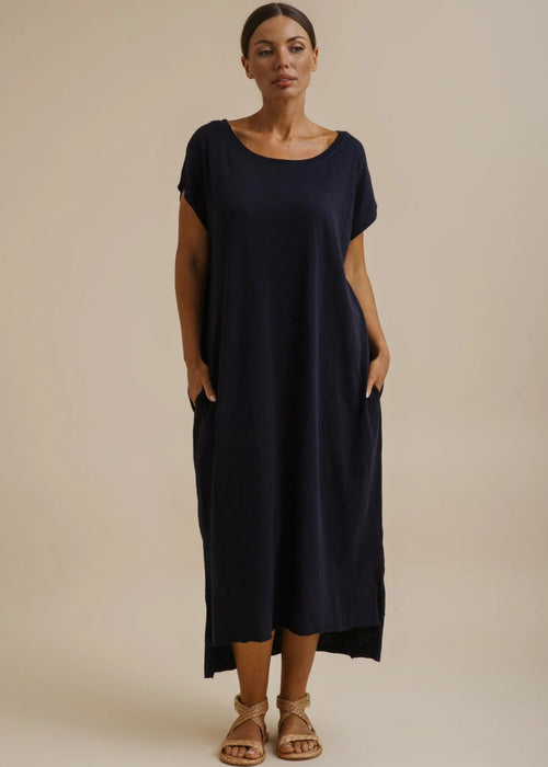 Woman wearing a blue dress on a beige background