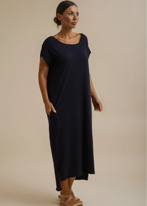 Woman wearing a blue dress on a beige background