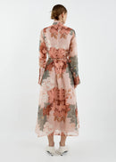 Woman wearing a floral dress with a white background