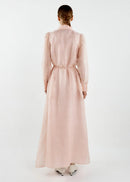 Person wearing a long pink dress on a white background