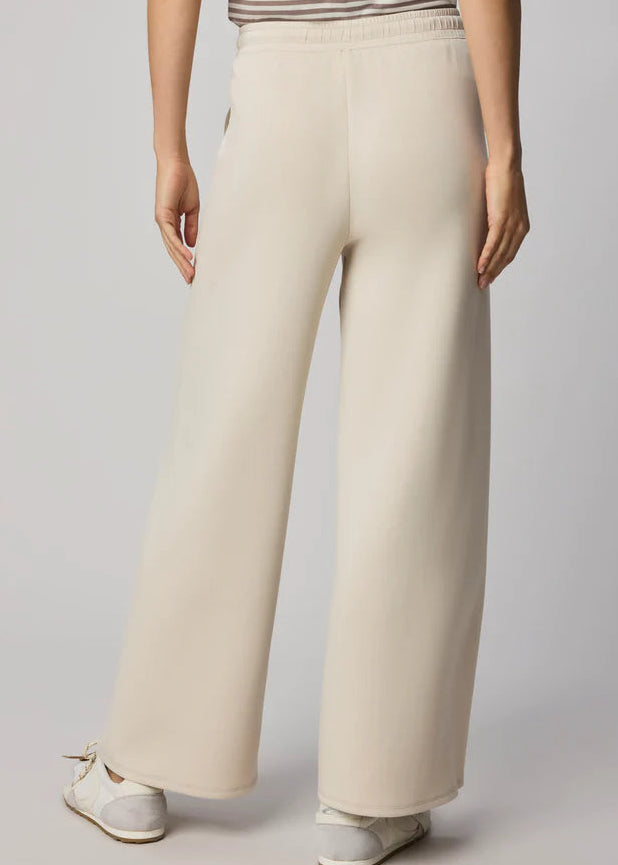 Beige sweatpants worn by a person on a plain background
