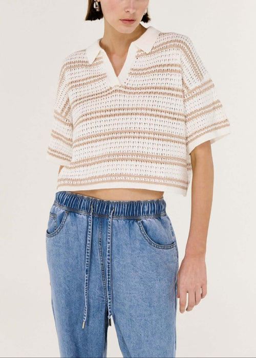 Woman wearing a striped shirt and blue jeans on a white background