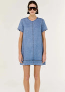 Woman wearing a blue denim dress on a white background