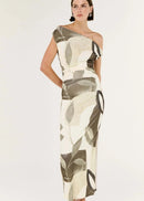 Woman wearing a one-shoulder patterned dress on a white background