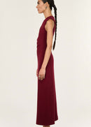 Woman wearing a burgundy sleeveless dress on a white background