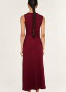 Woman wearing a burgundy dress with a white background