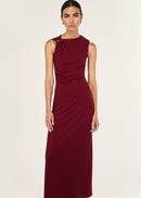Woman wearing a burgundy dress on a white background