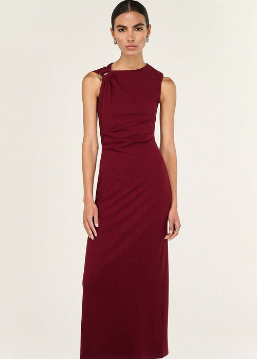 Woman wearing a burgundy dress on a white background