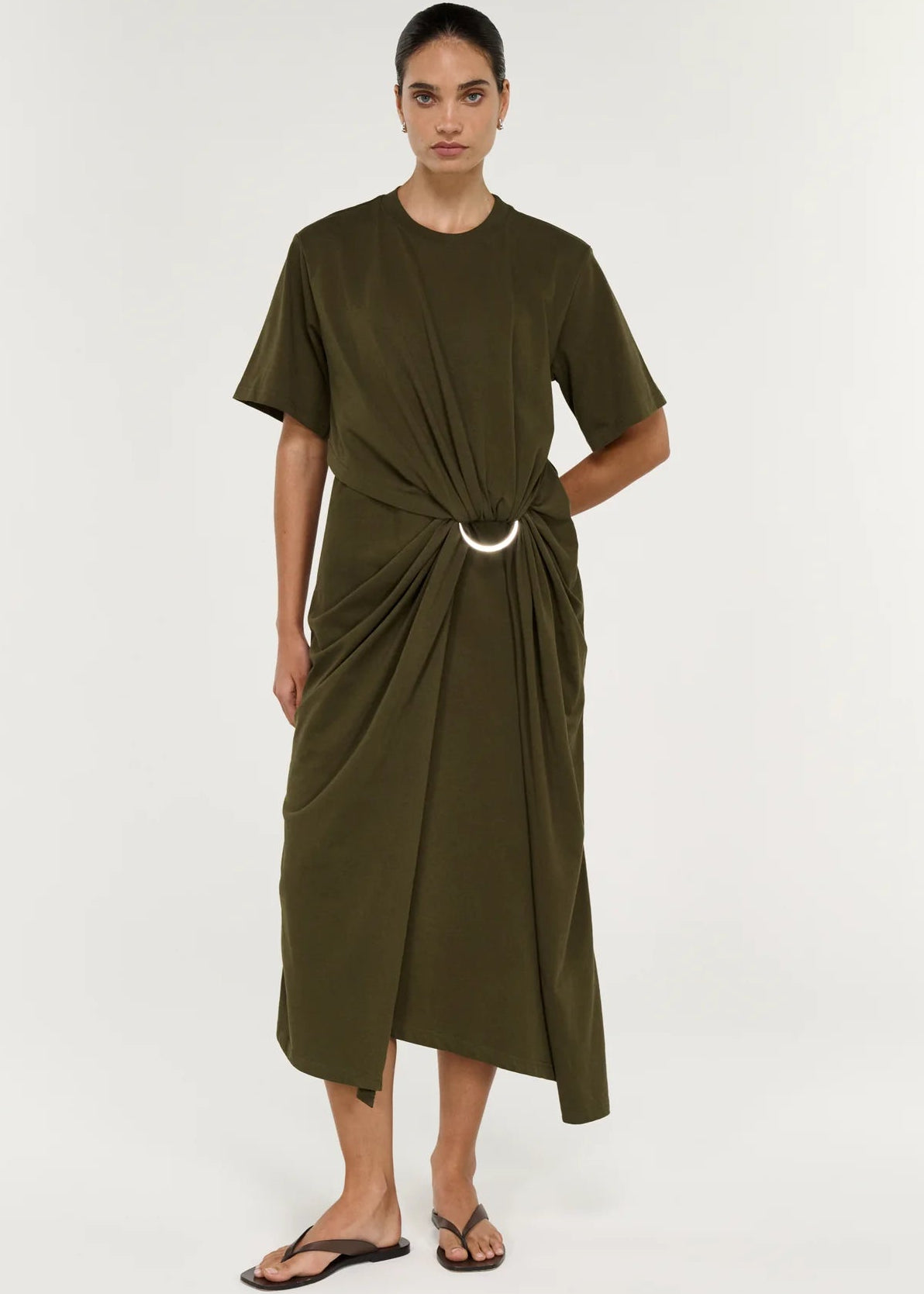 Woman modelling a olive dress on white studio background