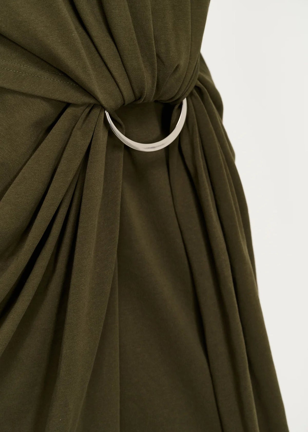Close up of silver ring tie and draping dress,