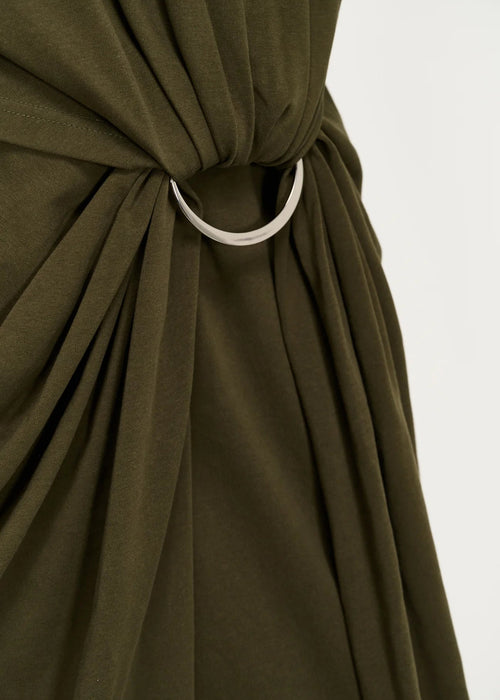 Close up of silver ring tie and draping dress,