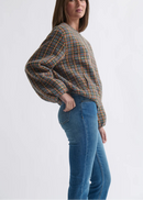 Woman wearing blue jeans on a white background