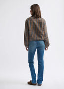 Woman wearing blue jeans on a white background