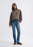 Woman wearing blue jeans on a white background