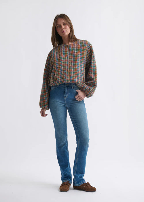 Woman wearing blue jeans on a white background