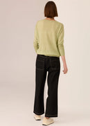 Woman in a knit top on white background