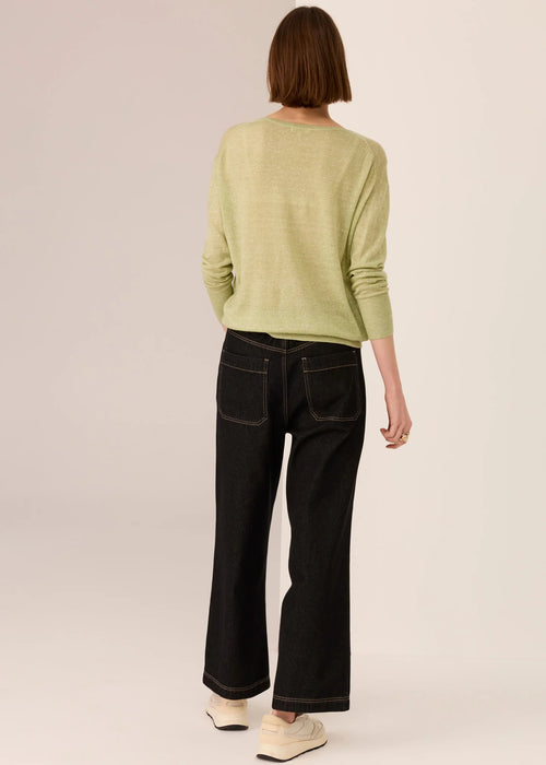 Woman in a knit top on white background