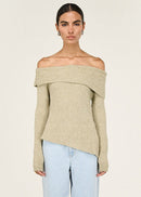 Woman wearing a beige off-shoulder sweater against a white background