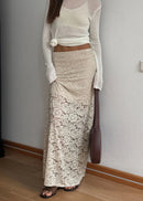 Woman in a white top and lace skirt  with a white background