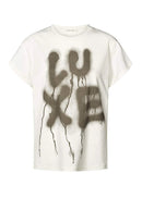 White t-shirt with 'LUXE' graphic design on a white background
