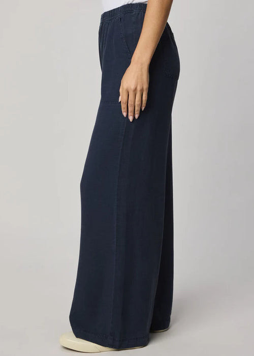 Navy blue wide-leg pants worn by a person on a plain background