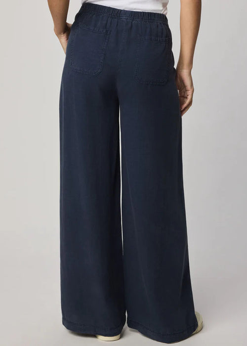 Navy blue wide-leg pants worn by a person on a plain background