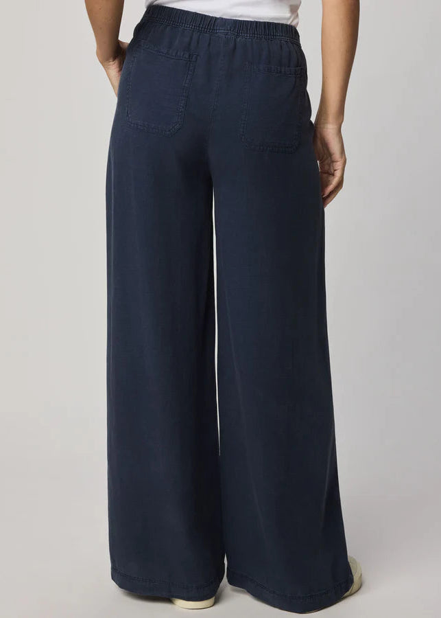 Navy blue wide-leg pants worn by a person on a plain background
