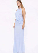 Woman wearing a light blue halter neck gown on a white background