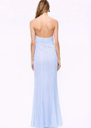 Woman wearing a light blue halter neck gown on a white background
