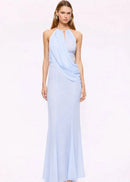 Woman wearing a light blue halter neck gown on a white background