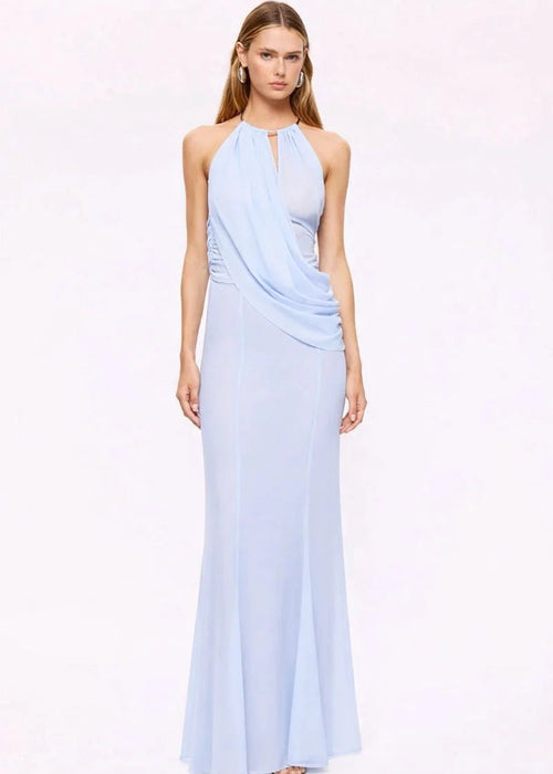 Woman wearing a light blue halter neck gown on a white background