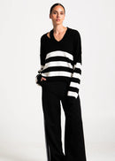 Woman wearing black and white stripe jumper on white background