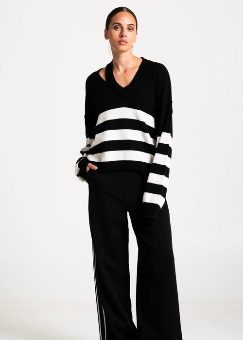 Woman wearing black and white stripe jumper on white background