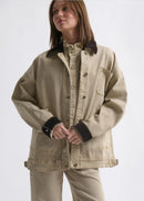 Woman wearing a beige jacket on white background