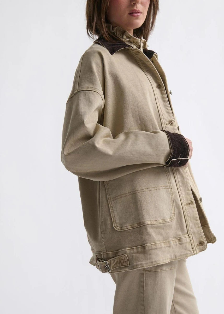 Woman wearing a beige jacket on white background
