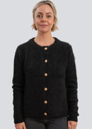 Woman wearing a black cardigan with button details on a light grey background