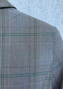 Gray checkered jacket on a textured light blue background